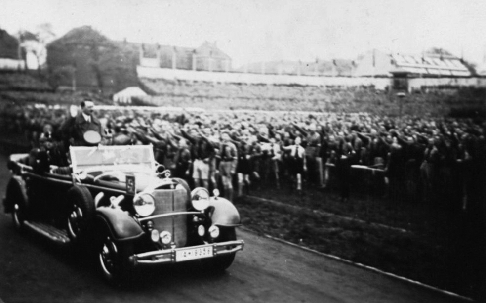 Adolf Hitler arriving to give a May Day address at Berlin's Poststadion, salutes the HJ formation